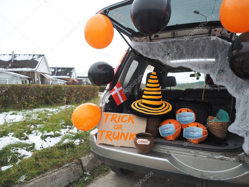 Trick or trunk. Concept celebrating Halloween in trunk of car. New trend celebrating traditional October holiday outdoor. Social distance and safe alternative celebration during coronavirus covid-19