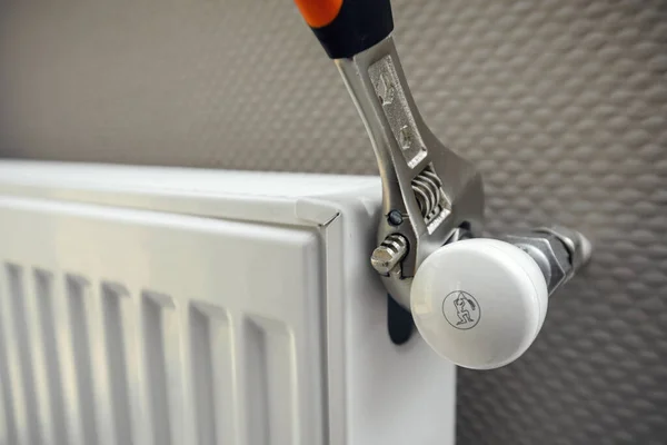 Close up of male plumber installing radiator with wrench — Stock Photo, Image