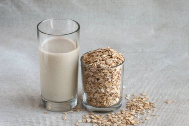Close up healthy oat milk in tall drinking glass with seed clipart