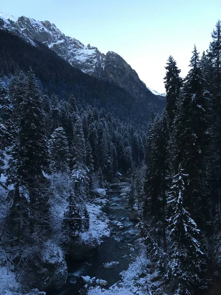 The photo was taken from a height, a calm mountain river in winter.