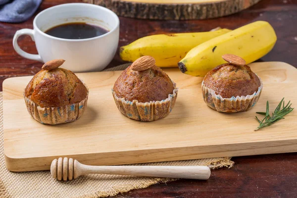 Banana cake on wooden board with banana and coffee for breakfast