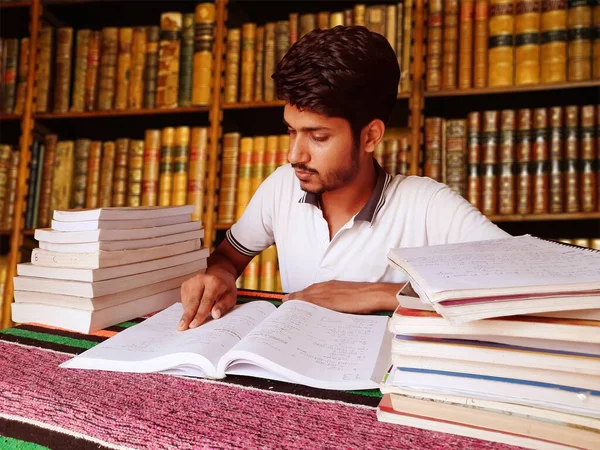 Student studying hard for exams in library