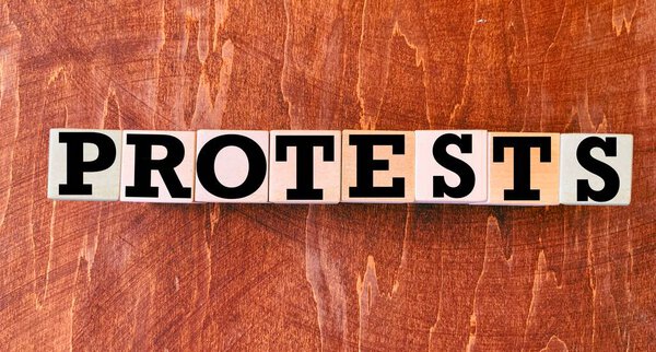 Protests on wooden blocks.The concept of a public movement to protest gun violence and shootings in the United States in connection with the death of George Floyd.