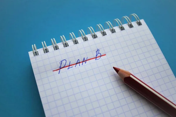 I have no plan B! On a bright blue background, a spiral notebook in a cage, the inscription Plan B, crossed out in red. Red pencil is right there on the notebook