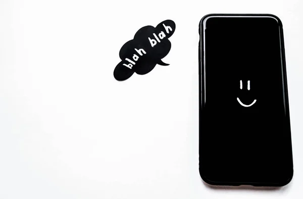 Black Smartphone White Eyes Smile Next Black Speech Bubble Says — Stock Photo, Image