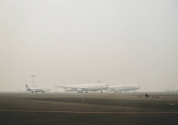 Moscow, Russia, August 2010: Planes stand at the airport in the fog. Flights were canceled due to the weather
