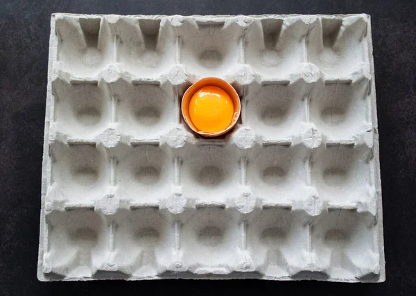 Polovina Čerstvého Vajíčka Jasným Žloutkem Papírovém Tácu Vejce Černém Pozadí — Stock fotografie