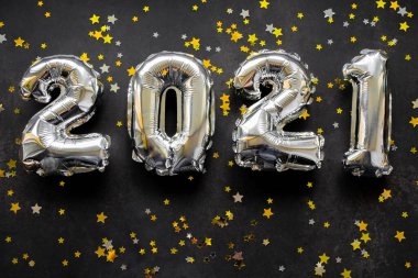 Şişirilebilir sayılara yakın yeni yıl 2021 'de parlak altın ve gümüş yıldızlı siyah arkaplan.