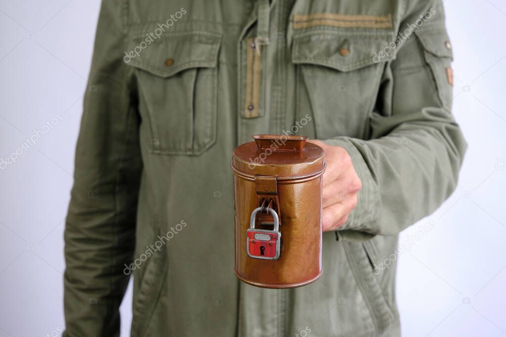 Man holdiong a vintage money collection box with padlock, spendensose. Collect money for a good cause. Isolated in white background