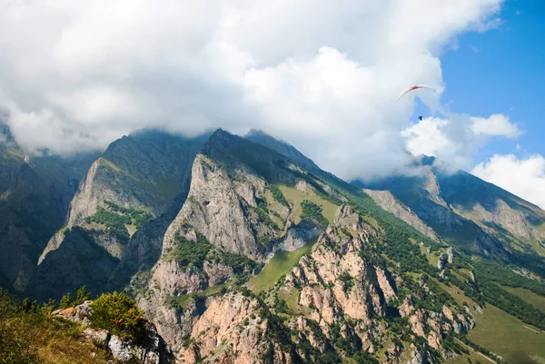 Vista del valle y las montañas, parapente volando en el cielo, día claro de verano, garganta chegemsky — Foto de Stock