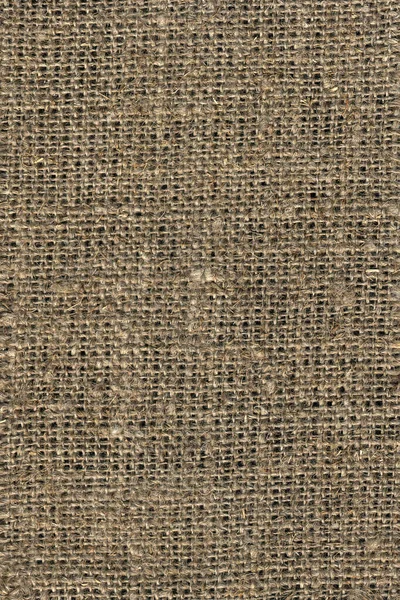 La textura de la tela está hecha de arpillera beige gruesa . — Foto de Stock