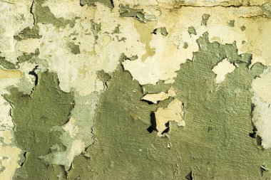 Yeşil boya renginde eski bir beton duvar. Çatlak dış doku arkaplanı