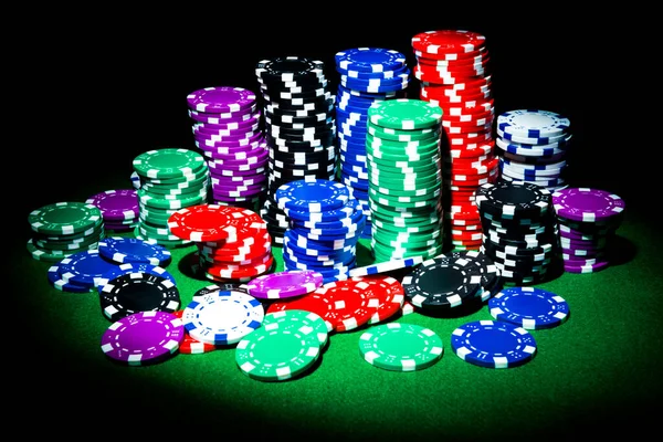 Poker chips on the game table with spectacular lighting. High quality photo