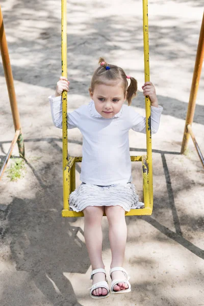 Serious girl on the swing — Stock Photo, Image