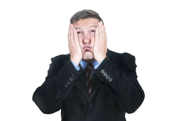 Surprised businessman clinging to his cheeks — Stock Photo, Image