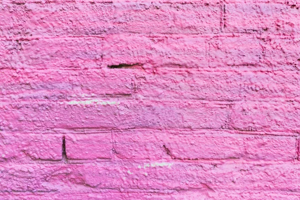 Pink old plastered brick wall