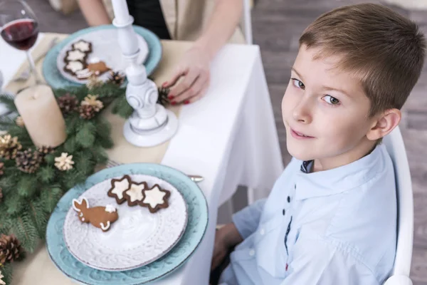 Boy at the christmas table — Stock Photo, Image