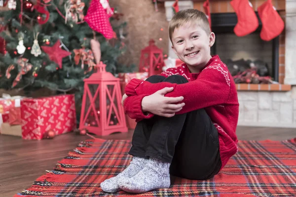 Portrait Smiling Boy Red Sweater Sitting Floor Embracing His Knees — Stock Photo, Image