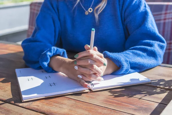 Woman holds hands on notebook — Stock Photo, Image