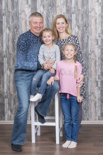 Family portrait at the chair — Stock Photo, Image