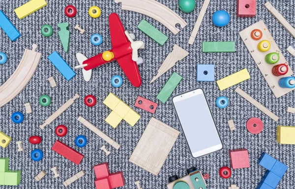 Scattered Wooden Toys Smartphone Soft Gray Carpet — Stock Photo, Image