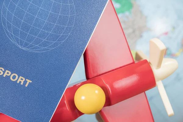 Passport and toy airplane at the globe — Stock Photo, Image