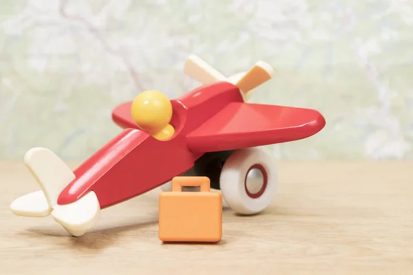 Miniature suitcase and toy plane — Stock Photo, Image