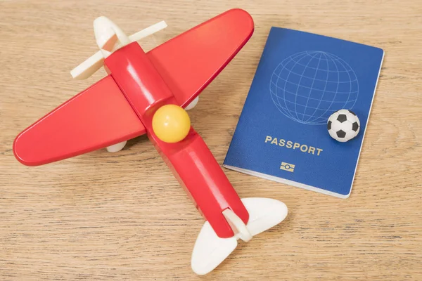 Soccer ball near airplane and passport — Stock Photo, Image