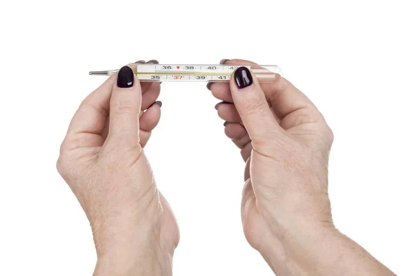 Women hands are holding a thermometer — Stock Photo, Image