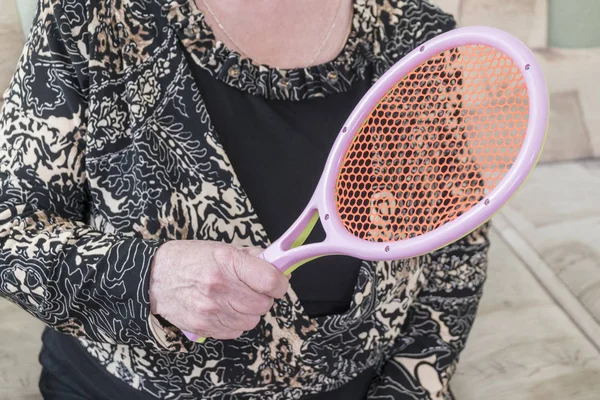 Old woman with racket