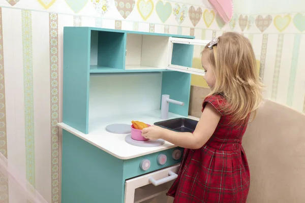 Bebé cocina en una estufa de juguete —  Fotos de Stock