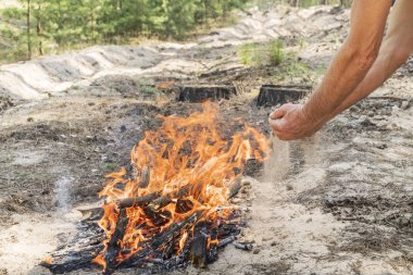 man putting out a fire with sand clipart