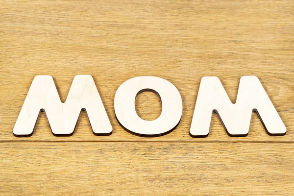 Word mom of wooden letters on table — Stock Photo, Image