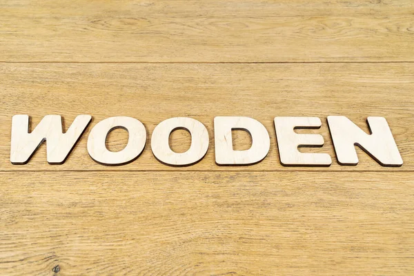 Woord houten op een oude tafel — Stockfoto