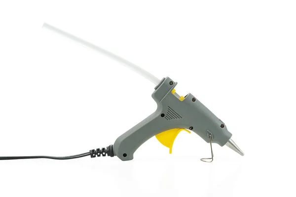 Small hot melt glue gun with sticking glue stick isolated on a white background