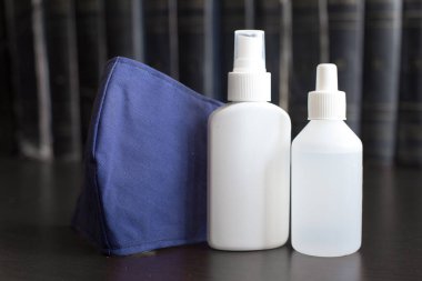 Karanlık Arkaplan 'daki yüz maskesi iki şişe dezenfektanla solunum cihazını gaz, buhar, gaz ve toz gibi maddeleri içeren tehlikeli atmosferleri solumaktan korur.