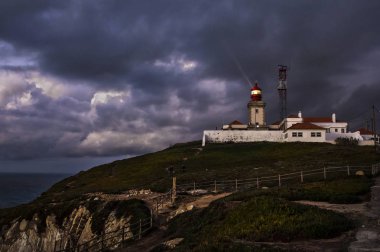 Dramatic night Portuguese landscape on the coast of Atlantic Ocean, the westernmost point of mainland Europe  at Cabo da Roca. Old  Lighthouse. clipart