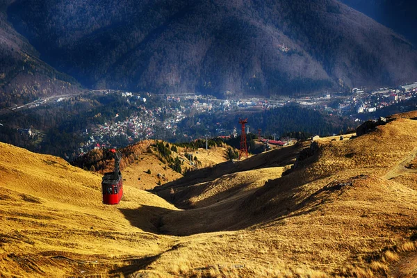 Beautiful landscape in autumn season with Prahova Valley. Red cable car transportation at 2000m in Bucegi Mountains, Sinaia, Romania