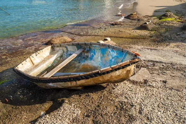 Peaceful scene in the morning, with a fishing boat,on the shore of the Capri Island