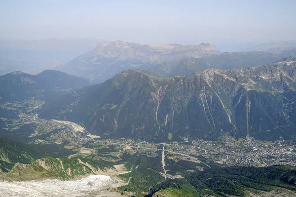 Foggy summer landscape with Chamonix aerial view and mountains in Mont Blanc, top massif in France. Most popular summer and winter, sports and touristic destination in French Alps.