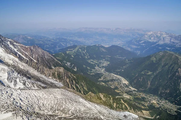 Foggy summer landscape with Chamonix aerial view and mountains in Mont Blanc, top massif in France. Most popular summer and winter, sports and touristic destination in French Alps.