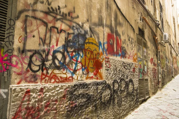 NAPLES, ITALY - NOVEMBER 13, 2015. Ancient wall with graffiti on the street in historic center of Naples, Italy.