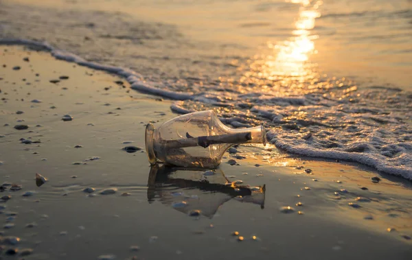 Message in a bottle on beach at sunrise. Wall art and home decoration.