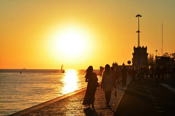 LISBON, PORTUGAL - OCTOBER 29, 2017. Recreation time at the sunset along the Tagus River, in the civil parish of Santa Maria de Belem in Lisbon, Portugal