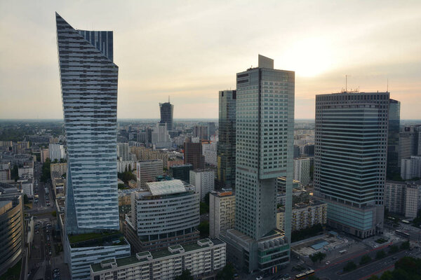 WARSAW, POLAND - JUNE 27, 2018. View from above and urban skyline with skyscrapers hotels and office ,with commercial buildings at sunset in Warsaw downtown, Poland.