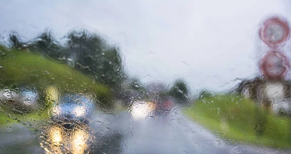 Abstract image with rainy weather on the road and traffic
