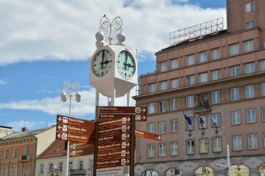 ZAGREB, CROATIA - JULY 15, 2017. White clock and street indicators at Ban Jelacic Square (Trg bana Jelacica) in Zagreb city, Croatia. clipart