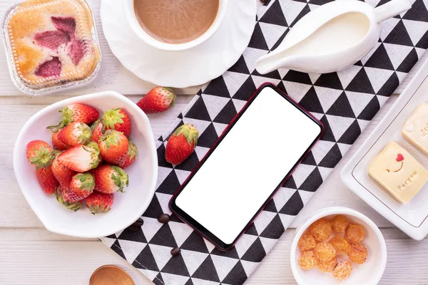 Blank screen on smartphone, cellphone, tablet with sweet dessert