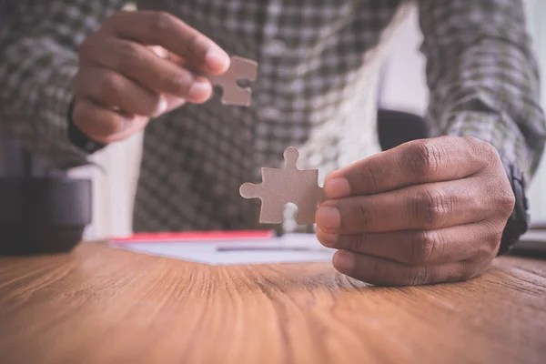 businessman doing a jigsaw, concept of business sucessful.