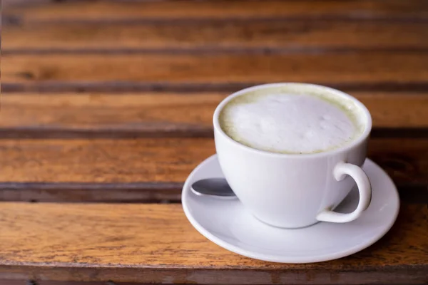 Taza de té verde caliente mucho en la mesa de madera . — Foto de Stock